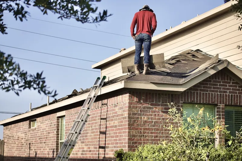 Professional roofer working on a residential roof in Marlin Forest